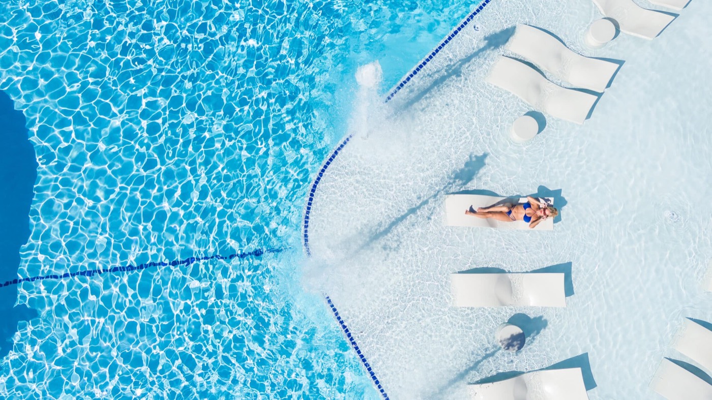 Guest relaxing on an in-pool lounger at the Main Pool
