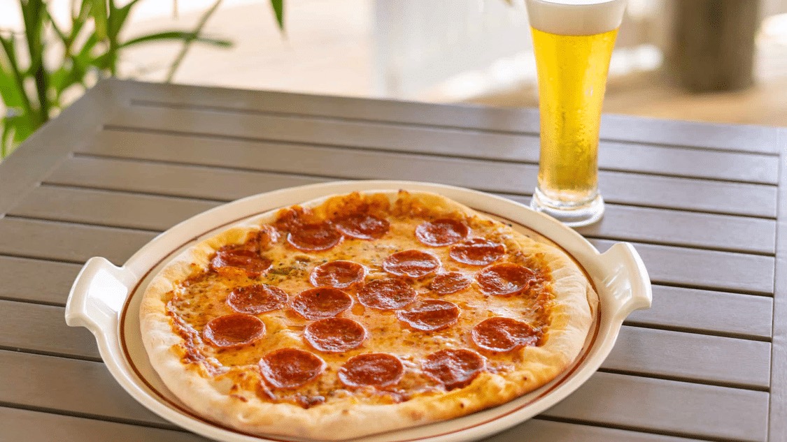 Pepperoni pizza and a cold beer at Papa Ricco's