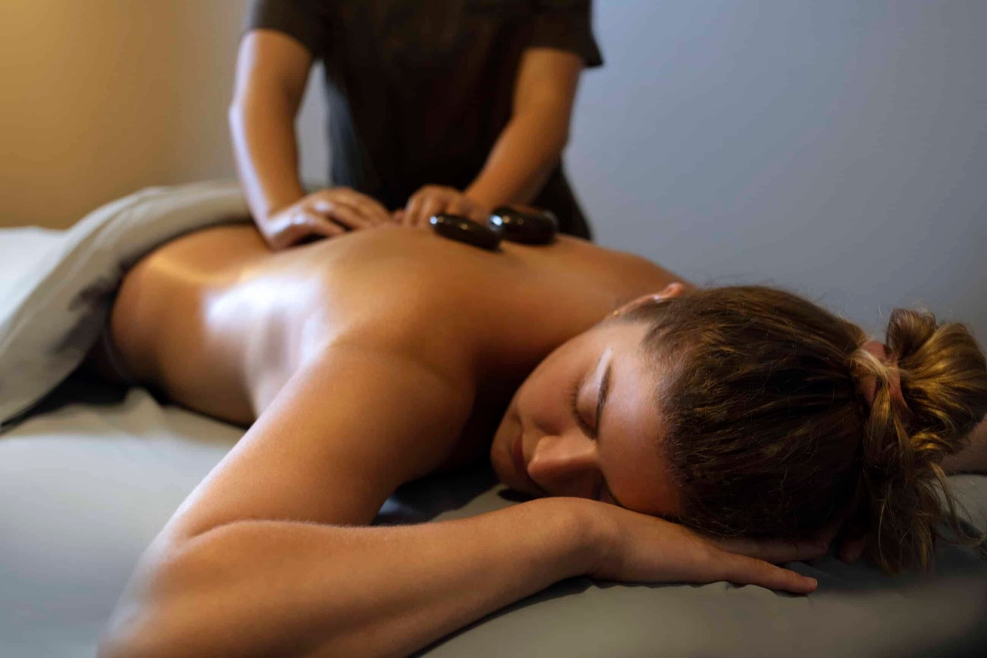 A guest receiving a hot stone massage